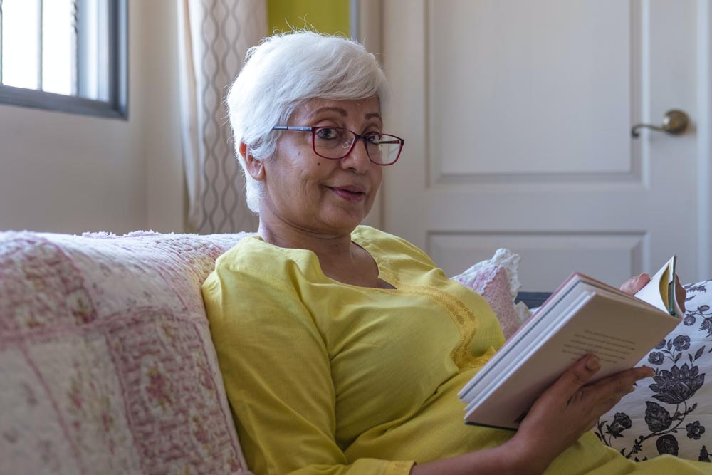 A senior adult woman reading a book